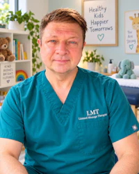 a man in scrubs sitting in front of a teddy bear